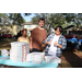 Three people at Domino's Pizza table at Spring Family Picnic event in Jordan Park on March 26, 2024.