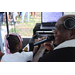 DJ Dondy holding microphone and a girl wearing a white shirt at the Spring Family Picnic event in Jordan Park on March 26, 2024.