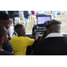 DJ Dondy and a child wearing a yellow shirt at the Spring Family Picnic event in Jordan Park on March 26, 2024.