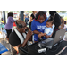 DJ Dondy with a mother and her child at the Spring Family Picnic event in Jordan Park on March 26, 2024.