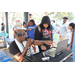 DJ Dondy and a child wearing a black hoodie at the Spring Family Picnic event in Jordan Park on March 26, 2024.