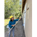 St. Petersburg Housing Authority (SPHA) woman wearing dark blue shirt painting Habitat for Humanity house.