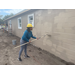 St. Petersburg Housing Authority (SPHA) woman outside painting Habitat for Humanity house.