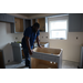 St. Petersburg Housing Authority (SPHA) team member working on kitchen cabinets.