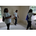 Three St. Petersburg Housing Authority (SPHA) team members measuring inside walls of Habitat for Humanity house.