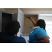 Habitat for Humanity homeowner working on kitchen cabinets.