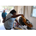 St. Petersburg Housing Authority (SPHA) team member cutting wood.