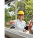 St. Petersburg Housing Authority woman wearing yellow hat and holding paint roller.