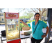 Woman standing next to popcorn machine at Spring Family Picnic in Jordan Park.
