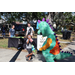 Great Explorations dinosaur mascot greeting child at Spring Family Picnic in Jordan Park.