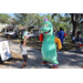 Great Explorations dinosaur mascot dancing with child at Spring Family Picnic in Jordan Park.
