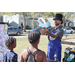Man wearing top hat twisting a balloon creation at Spring Family Picnic in Jordan Park.