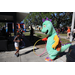 Great Explorations dinosaur mascot playing with child at Spring Family Picnic in Jordan Park.