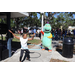 Great Explorations dinosaur mascot and child hula-hooping at Spring Family Picnic in Jordan Park.