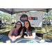Two people at WUSF NPR table at Spring Family Picnic in Jordan Park.
