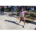 Girl with face painted hula-hooping on sidewalk at Spring Family Picnic in Jordan Park.