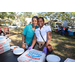 Two SPHA team members at Domino's Pizza table at Spring Family Picnic in Jordan Park.
