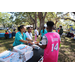 SPHA team members giving pizza to attendee at Domino's Pizza table at Spring Family Picnic in Jordan Park.