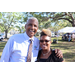 Man wearing tie and woman wearing sunglasses smiling at Spring Family Picnic in Jordan Park.