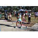 Youth hula-hooping on sidewalk and grass at Spring Family Picnic in Jordan Park.