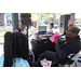 DJ holding microphone and talking with youth at Spring Family Picnic in Jordan Park.