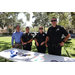  Four people at St. Petersburg Police Department table at Back to School Event in Jordan Park 2025. 