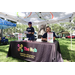  Two people at The Hub table at Back to School Event in Jordan Park 2025. 