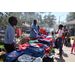  Three SPHA team members and a group of people at backpack table at Back to School Event in Jordan Park 2025. 