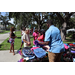  SPHA team member wearing a light blue shirt handing out backpacks at Back to School Event in Jordan Park 2025. 