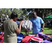  A woman and a SPHA team member holding backpacks at Back to School Event in Jordan Park 2025. 