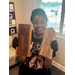  Student holding two pieces of wood at Summer Construction Camp 2025. 