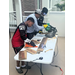  Two students and teacher cutting wood outside at Summer Construction Camp 2025. 