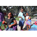  People holding backpacks at Back to School Event in Jordan Park 2025. 