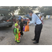  Person handing out candy to children at Trunk or Treat event. 