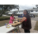  Two people standing by table at Trunk or Treat event. 