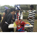  Group of people standing at snack table at Trunk or Treat event. 
