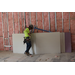  Interior of The Edward White Campus and a construction worker with drywall. 
