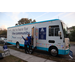  BayCare team members and the BayCare bus at the Very Merry Holiday Party in Jordan Park. 