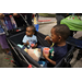  Two children sitting in a wagon at Very Merry Holiday Party in Jordan Park. 