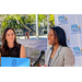  Danielle Thomas, SPHA Sr. Vice President / COO, speaking at a microphone, with Elodie Dorso, CEO and President of Evara Health, standing next to her. 