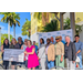  U.S. Rep. Kathy Castor presenting a check for $3.15 million to the St. Petersburg Housing Authority with a blue sky in the background. 