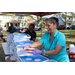  Two SPHA team members handing out pizza at the Spring Family Picnic event in Jordan Park on March 10, 2026. 