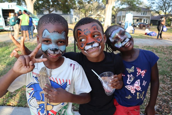 Three children with their faced painted at the Spring Family Picnic event in Jordan Park on March 10, 2026.